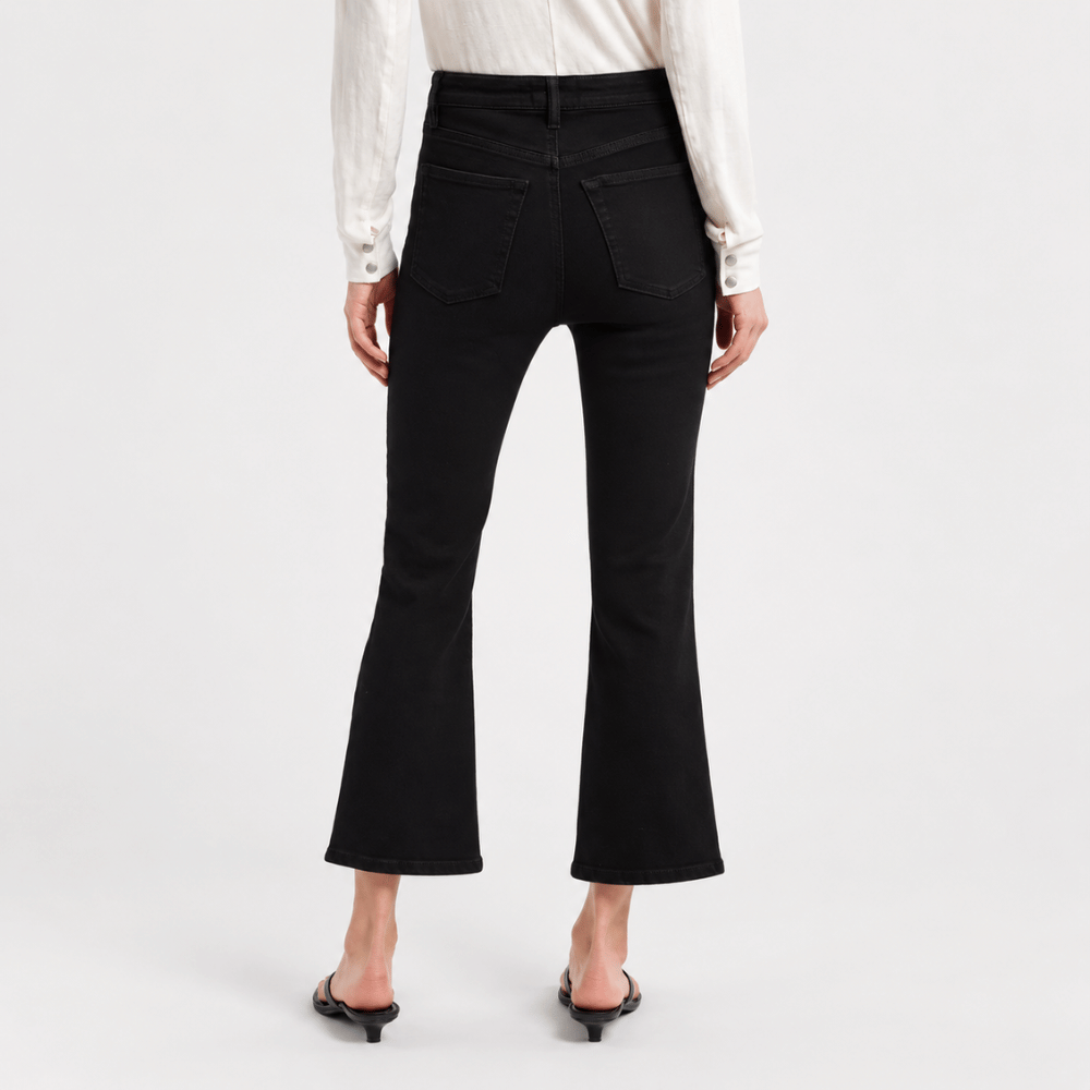 FRAME The Reboot Crop Jeans in Levitate at Riada Concept. High-rise black bootcut jeans in super-stretch denim with a 27-inch inseam and cropped flare - back view