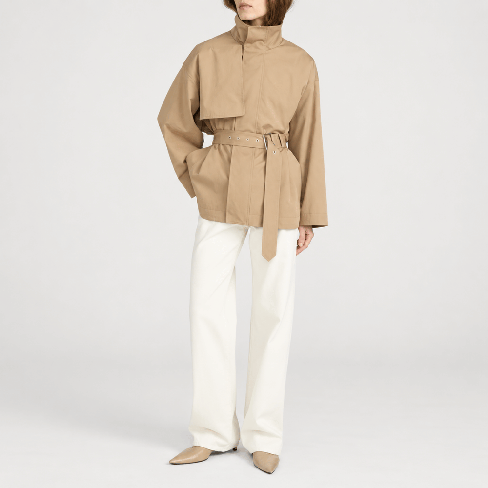 FRAME The Short Field Trench in Khaki at Riada Concept. Relaxed cotton jacket with a stand collar, storm flap and adjustable belt - styled model front view