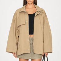 FRAME The Short Field Trench in Khaki at Riada Concept. Relaxed cotton jacket with a stand collar, storm flap and adjustable belt - worn open, front view