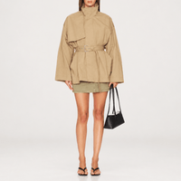 FRAME The Short Field Trench in Khaki at Riada Concept. Relaxed cotton jacket with a stand collar, storm flap and adjustable belt - styled model front view