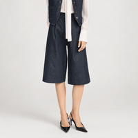 FRAME The Tailored Short in Rinse at Riada Concept. High-rise rigid denim Bermuda shorts with front pleats and a wide culotte leg - front view