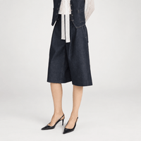 FRAME The Tailored Short in Rinse at Riada Concept. High-rise rigid denim Bermuda shorts with front pleats and a wide culotte leg - side view