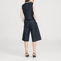 FRAME The Tailored Short in Rinse at Riada Concept. High-rise rigid denim Bermuda shorts with front pleats and a wide culotte leg - back view