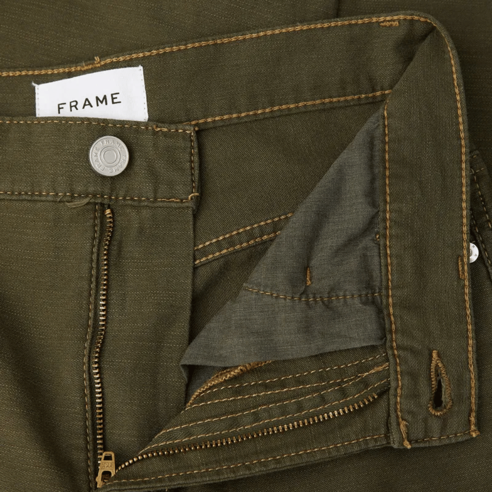 RAME Ultra High Rise Barrel Jeans in Washed Fatigue at Riada Concept. Ultra-high-rise olive cargo jeans in rigid cotton - close-up waistband and zip