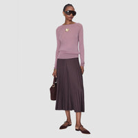 Model wearing the JOSEPH Geras cashmere jumper in lilac with a pleated midi skirt, full length
