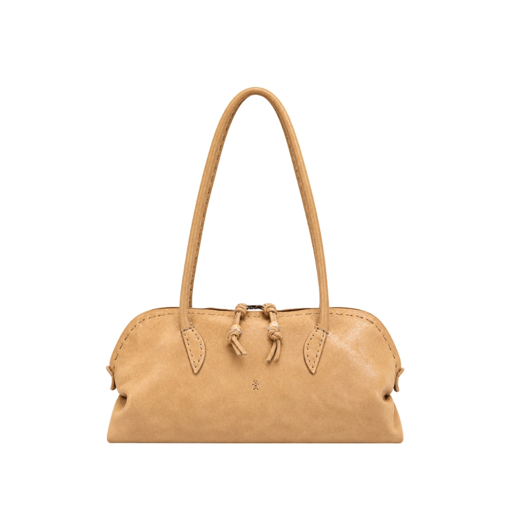 Riada Concept Henry Beguelin’s Bolla Bassa in camel Old Iron lambskin: a low, elongated shoulder bag, hand-worked in Italy, that softens and deepens in colour with wear.