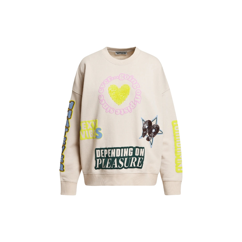 Riada Concept Essentiel Antwerp relaxed cream cotton sweatshirt, covered in colourful slogans, with a sequinned heart, beaded sleeve lettering and a 1999 back panel