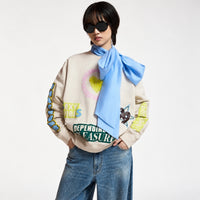Riada Concept Essentiel Antwerp relaxed cream cotton sweatshirt, covered in colourful slogans, with a sequinned heart, beaded sleeve lettering and a 1999 back panel, front model crop view