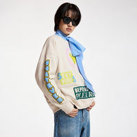 Riada Concept Essentiel Antwerp relaxed cream cotton sweatshirt, covered in colourful slogans, with a sequinned heart, beaded sleeve lettering and a 1999 back panel, crop model angle view