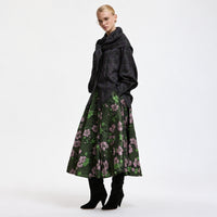 Riada Concept A full circle midi skirt by Essentiel Antwerp in khaki floral jacquard with pink and green flowers, a fitted waistband, side-seam pockets and a full lining - styled model angle view