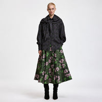 Riada Concept A full circle midi skirt by Essentiel Antwerp in khaki floral jacquard with pink and green flowers, a fitted waistband, side-seam pockets and a full lining - styled model front view