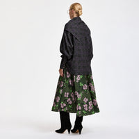 Riada Concept A full circle midi skirt by Essentiel Antwerp in khaki floral jacquard with pink and green flowers, a fitted waistband, side-seam pockets and a full lining - styled model back view