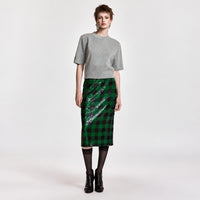 Riada Concept Essentiel Antwerp green and black check pencil skirt, covered in sequins on stretch jersey, with an elasticated waistband and a back slit. Midi length - front full model view