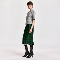 Riada Concept Essentiel Antwerp green and black check pencil skirt, covered in sequins on stretch jersey, with an elasticated waistband and a back slit. Midi length - angle view