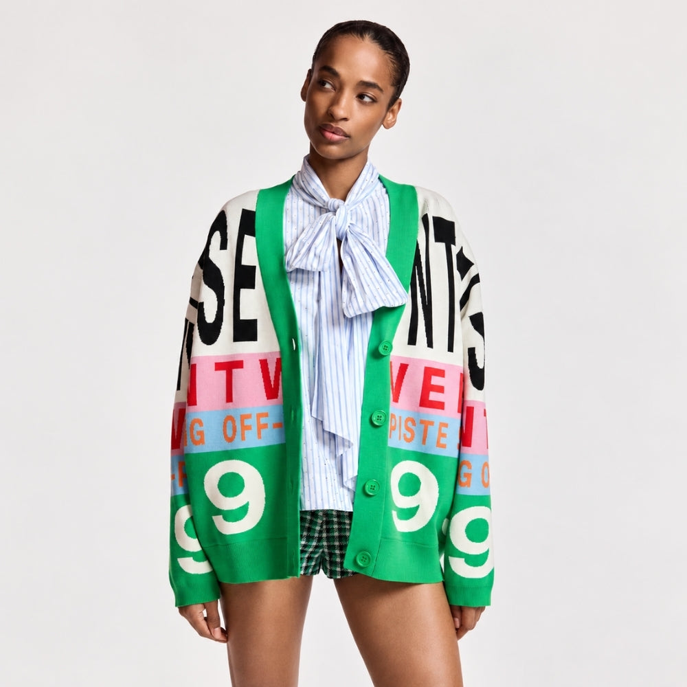 Riada Concept Essentiel Antwerp Kreezer V-neck cardigan with oversized logo intarsia in cream, pink, sky blue and green. Relaxed fit. Model cropped front view
