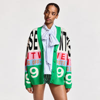 Riada Concept Essentiel Antwerp Kreezer V-neck cardigan with oversized logo intarsia in cream, pink, sky blue and green. Relaxed fit. Model cropped front view