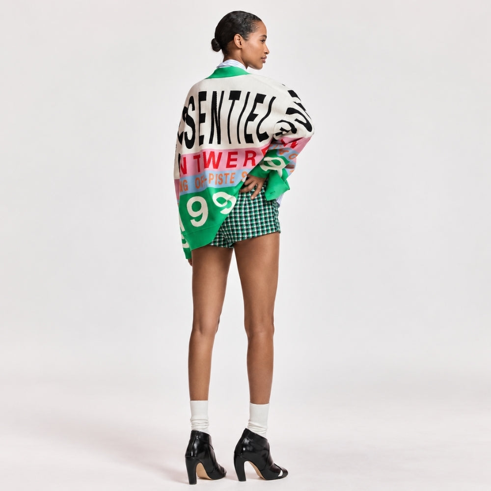 Riada Concept Essentiel Antwerp Kreezer V-neck cardigan with oversized logo intarsia in cream, pink, sky blue and green. Relaxed fit. Model styled back view