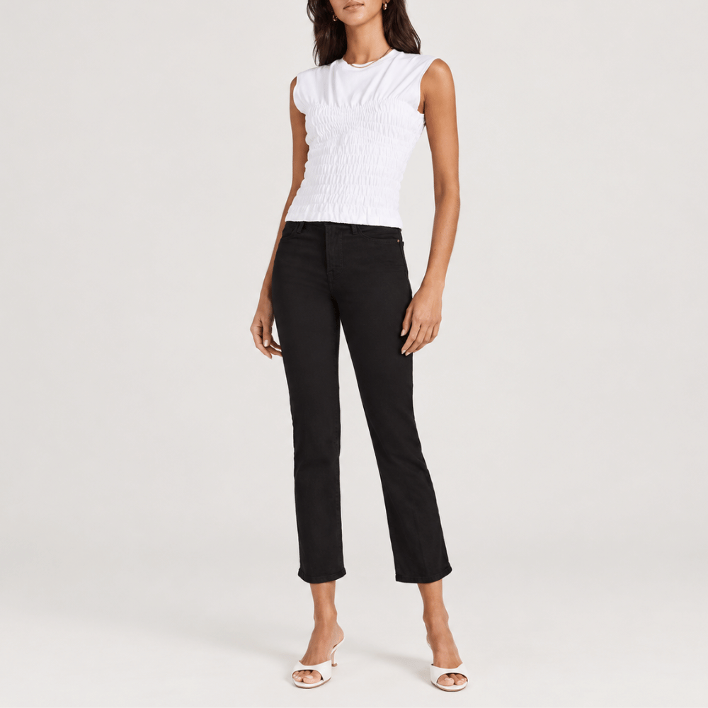 FRAME Le High Straight Ankle Jeans in Film Noir at Riada Concept. High-rise slim straight jeans in ultra-stretch black denim - styled model front view