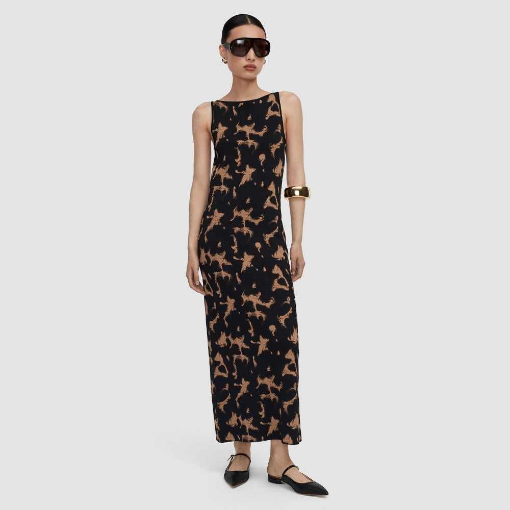 Model wearing the JOSEPH Lecate tortoiseshell knit dress with black flats and a gold cuff, full length