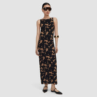 Model wearing the JOSEPH Lecate tortoiseshell knit dress with black flats and a gold cuff, full length