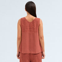 A sleeveless brick tank by Transit Par Such with a V-neck, a linen upper and a viscose georgette lower that widens to the hem - back view