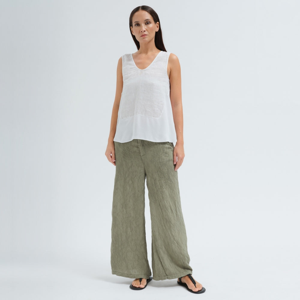 A sleeveless white tank by Transit Par Such with a V-neck, a linen upper and a viscose georgette lower that widens to the hem - model front view
