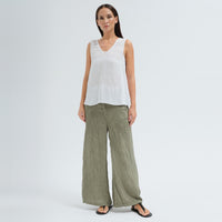 A sleeveless white tank by Transit Par Such with a V-neck, a linen upper and a viscose georgette lower that widens to the hem - model front view