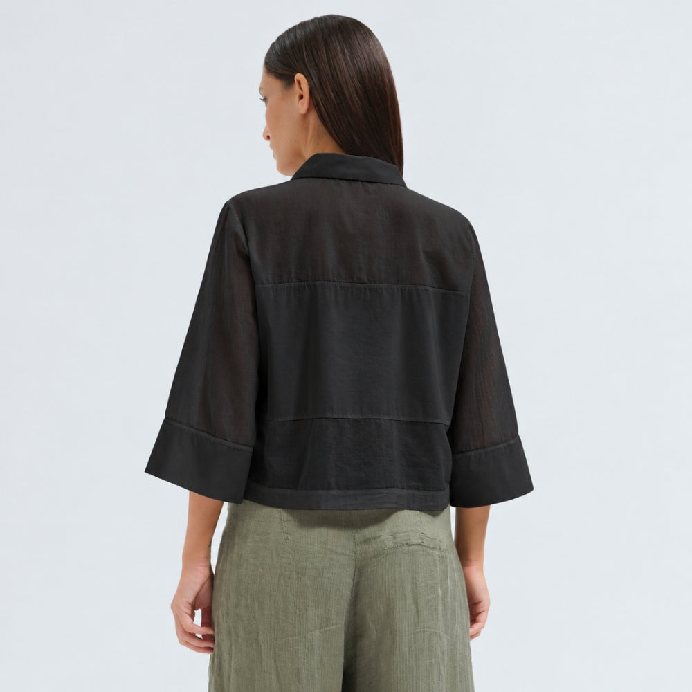 A boxy, cropped black shirt by Transit Par Such in stretch poplin with sheer panels, a pointed collar and three-quarter sleeves with wide cuffs - back view