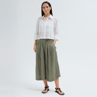 A boxy, cropped black shirt by Transit Par Such in stretch poplin with sheer panels, a pointed collar and three-quarter sleeves with wide cuffs - full model front view
