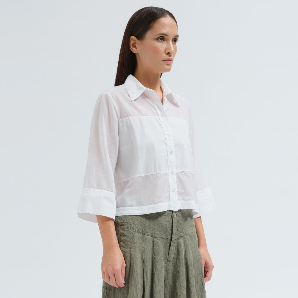 A boxy, cropped black shirt by Transit Par Such in stretch poplin with sheer panels, a pointed collar and three-quarter sleeves with wide cuffs - side view