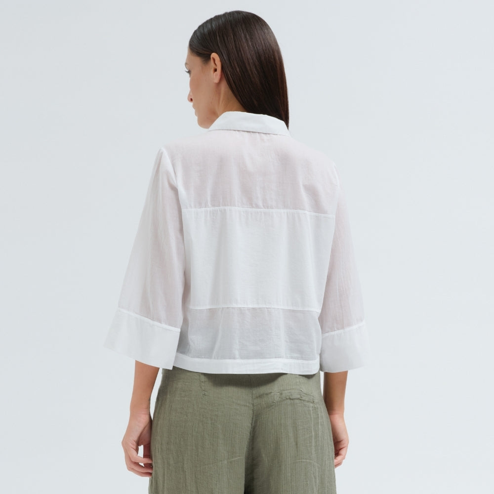 A boxy, cropped black shirt by Transit Par Such in stretch poplin with sheer panels, a pointed collar and three-quarter sleeves with wide cuffs - back view