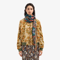 Riada Concept Pierre-Louis Mascia silk diamond scarf with red and orange florals on deep teal-blue and a gold-edged border. Made in Italy - styled model
