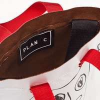 Plan C Pili & Bianca Mini Shopper Bag in Optical White with black graphic artwork, red handles and shoulder strap - brown interior