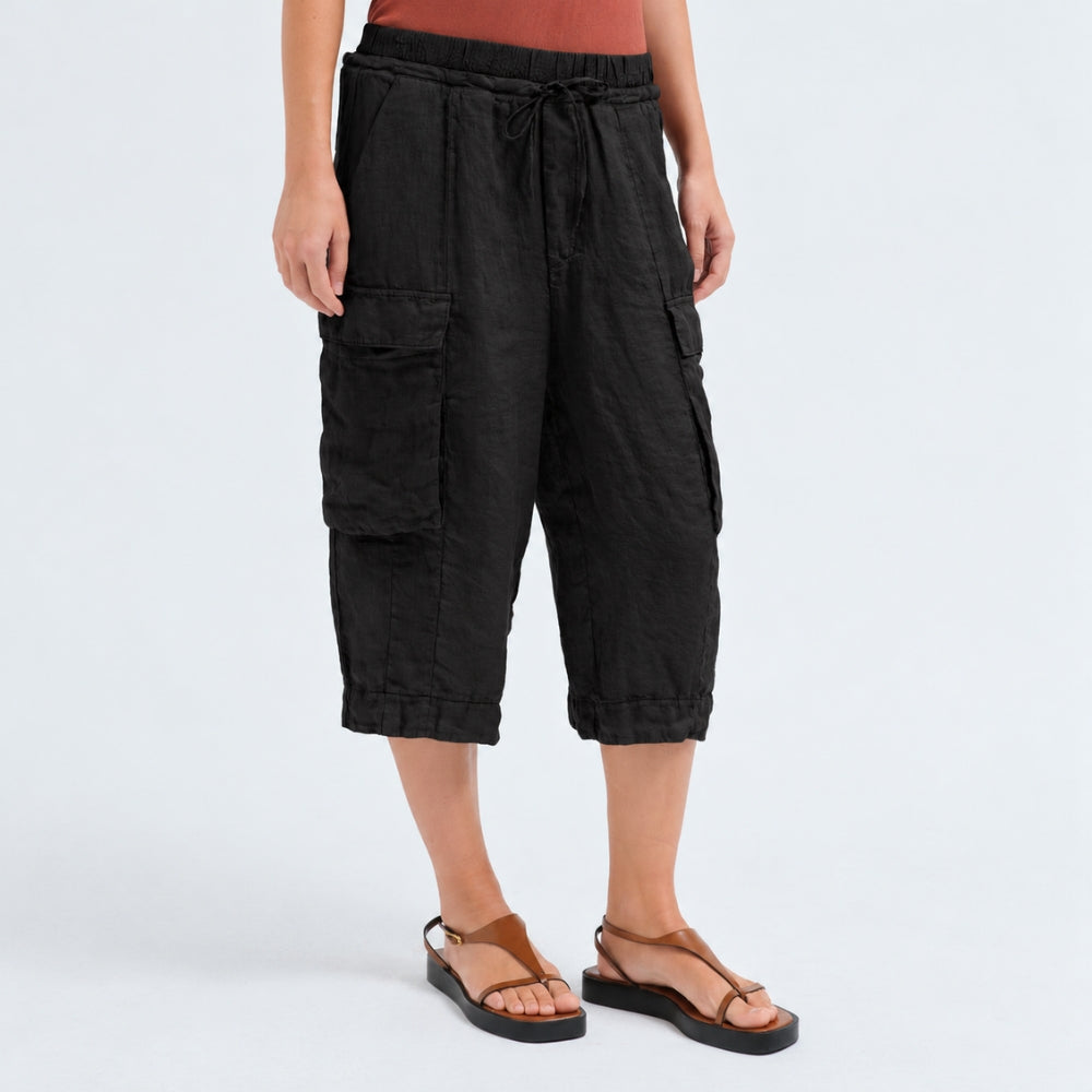 Wide linen cargo Bermuda shorts by Transit Par Such in black, falling below the knee, with flap cargo pockets and a drawstring elastic waist - angle view