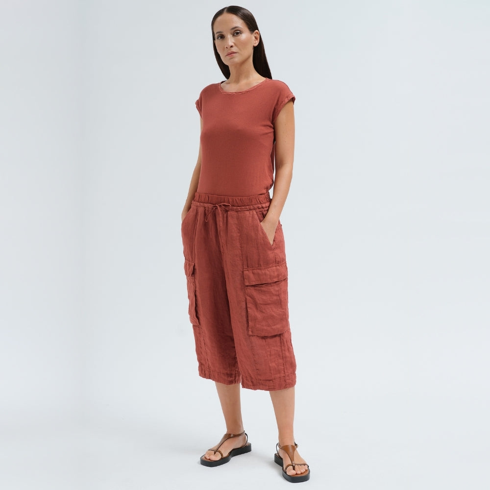 Wide linen cargo Bermuda shorts by Transit Par Such in brick, falling below the knee, with flap cargo pockets and a drawstring elastic waist - full front model view