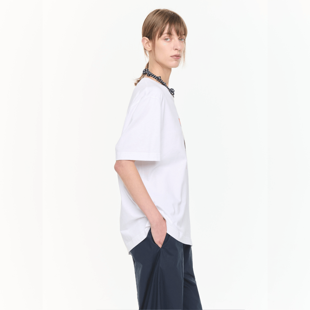 Plan C Self Portrait Print Cotton T-Shirt in Optical White with red graphic artwork styled on model side profile