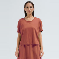 A sculptural, boxy T-shirt by Transit Par Such in brick cotton jersey, cropped to sit neatly at a high waist, with a round neck and short sleeves - front view