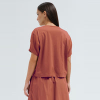 A sculptural, boxy T-shirt by Transit Par Such in brick cotton jersey, cropped to sit neatly at a high waist, with a round neck and short sleeves - back view
