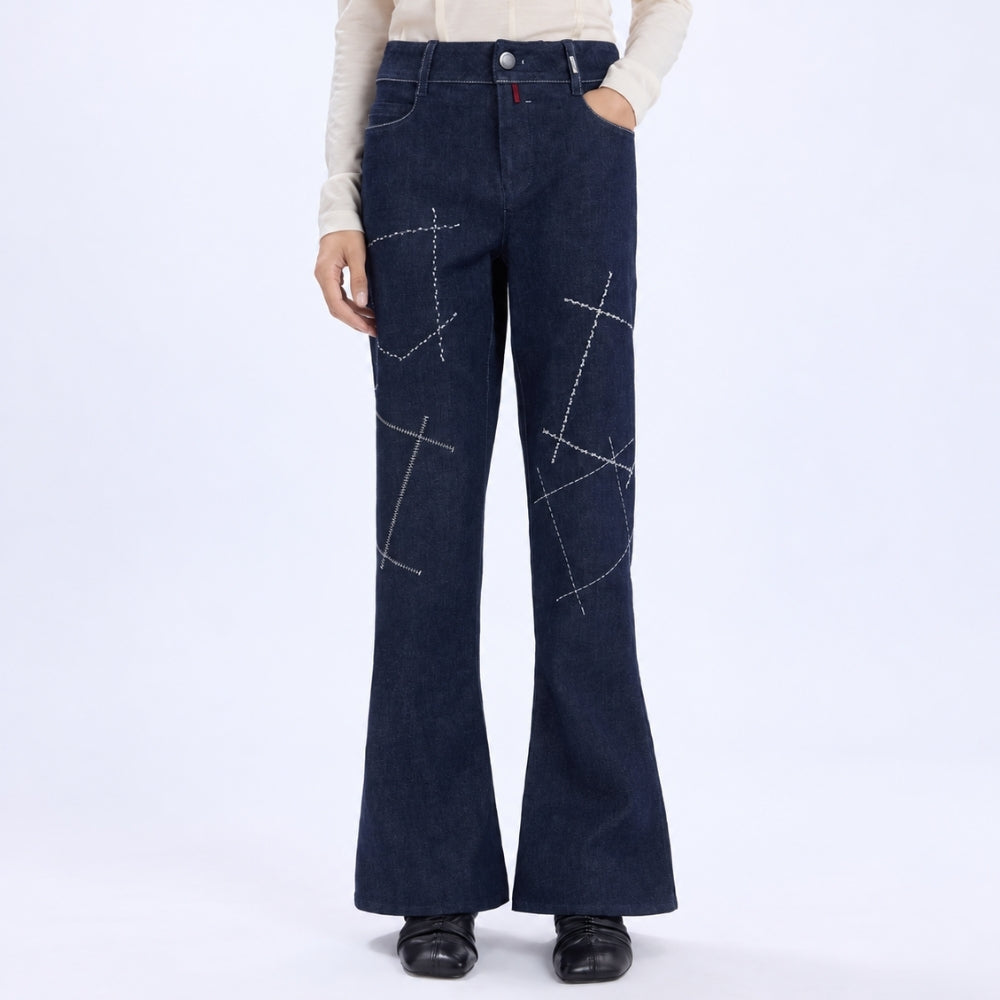 HIGH Everyday Couture Stardom bootcut jeans in deep blue denim with off-white geometric embroidery, front model view