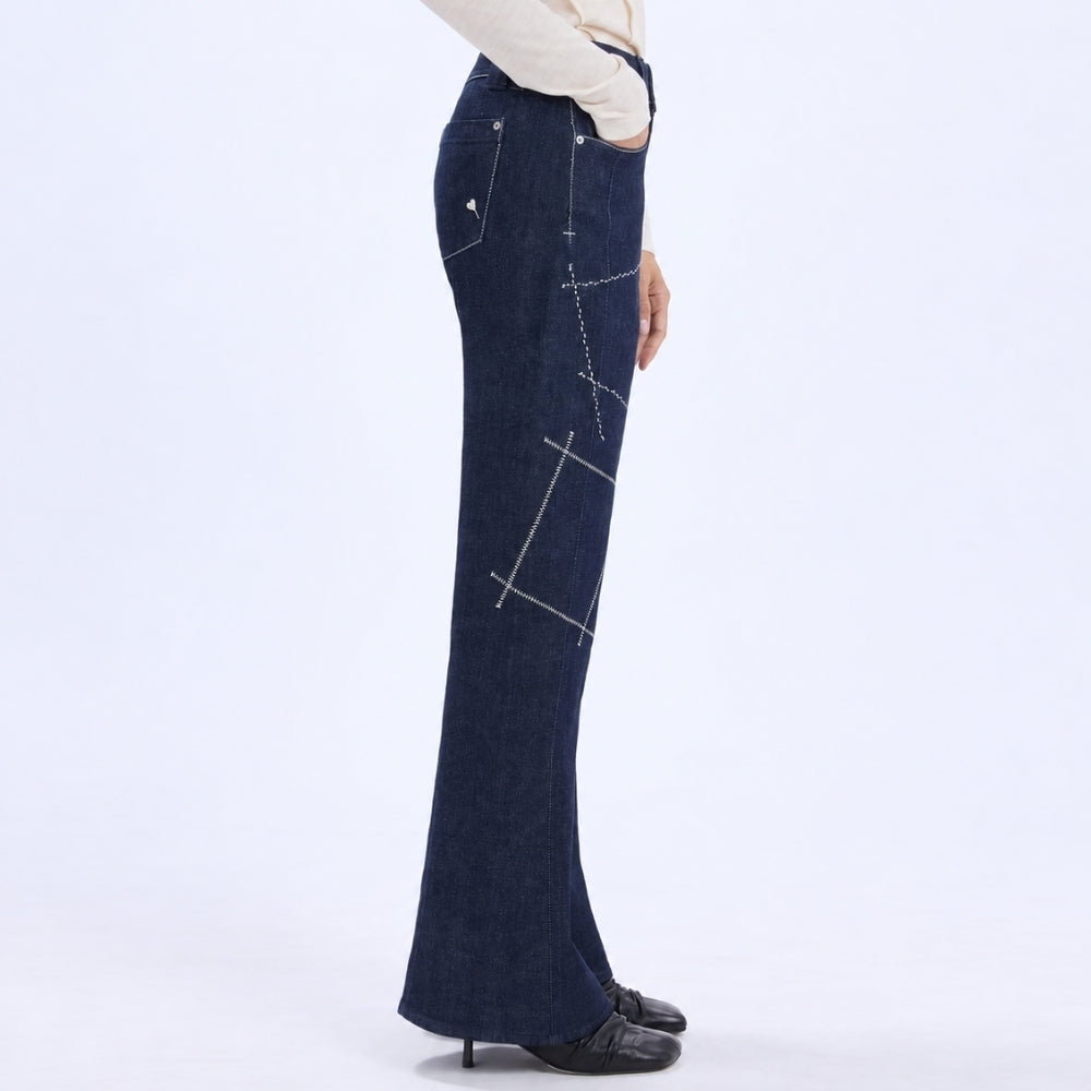 HIGH Everyday Couture Stardom bootcut jeans in deep blue denim with off-white geometric embroidery, side view