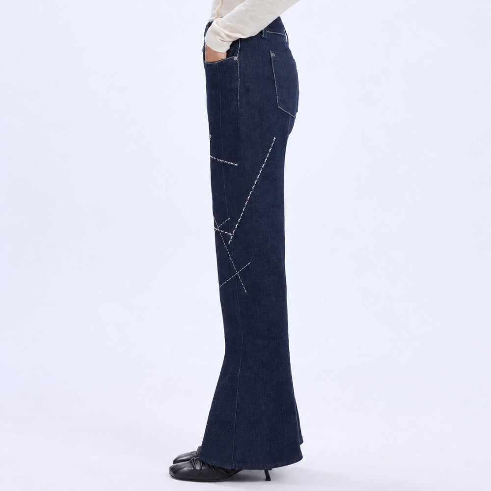 HIGH Everyday Couture Stardom bootcut jeans in deep blue denim with off-white geometric embroidery, left side view