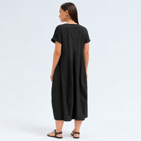 A below-the-knee V-neck dress by Transit Par Such in black stretch cotton, with a high-cut waist, cuffed short sleeves and side pockets - back view