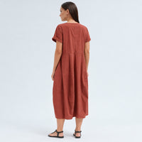 A below-the-knee V-neck dress by Transit Par Such in brick stretch cotton, with a high-cut waist, cuffed short sleeves and side pockets - back view