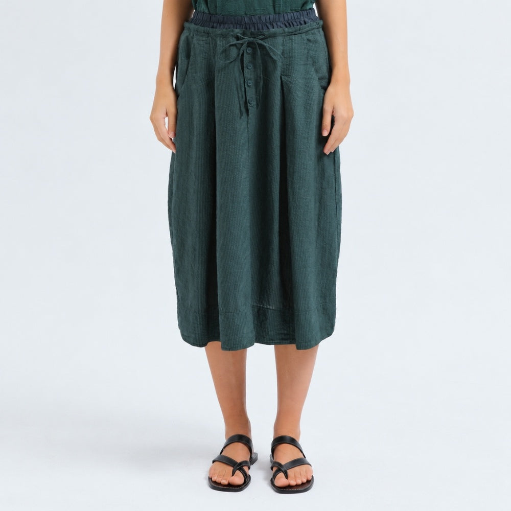 A flared midi skirt by Transit Par Such in petrol striped linen and cupro, with a drawstring waist, button detail at the front and slant pockets - front view