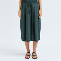A flared midi skirt by Transit Par Such in petrol striped linen and cupro, with a drawstring waist, button detail at the front and slant pockets - front view