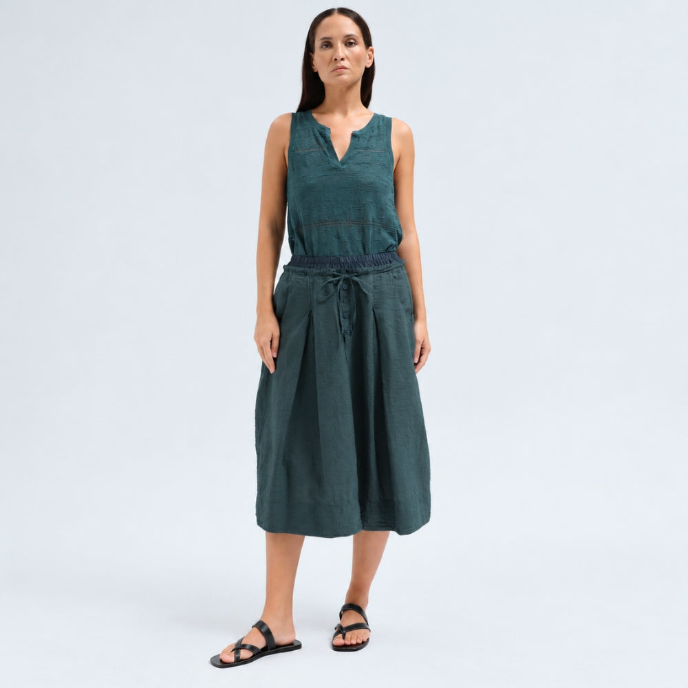 A flared midi skirt by Transit Par Such in petrol striped linen and cupro, with a drawstring waist, button detail at the front and slant pockets - front model view