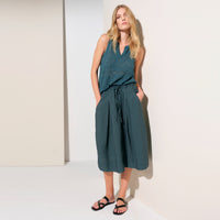 A flared midi skirt by Transit Par Such in petrol striped linen and cupro, with a drawstring waist, button detail at the front and slant pockets - full body styled model view