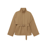 The FRAME The Short Field Trench in Khaki reimagines classic utility outerwear with a modern, structured silhouette.