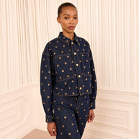Riada Concept Ulla Johnson Bobbi dark indigo denim jacket embellished with gold sequinned flowers and gold-tone buttons - styled model front view