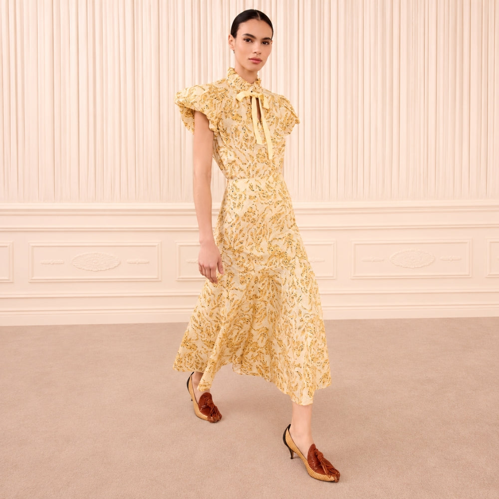 Riada Concept Ulla Johnson Clarisse high-waisted cotton poplin trumpet midi skirt in a pale yellow print - styled model view